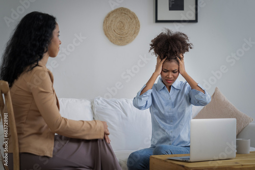 Sad PTSD woman patient in crucial therapy for mental health with psychologist, depression or grief after life failure. Frustrated trauma young woman talking to a psychologist about emotion in clinic