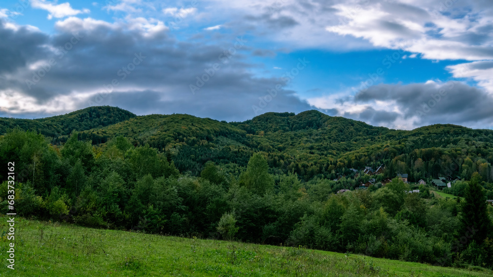 Green “waves” of the Carpathian ridges against the backdrop of the heavenly “sea”