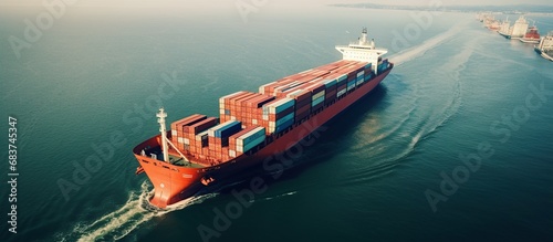 Aerial view a large container cargo ship travels over calm blue ocean. AI generated image
