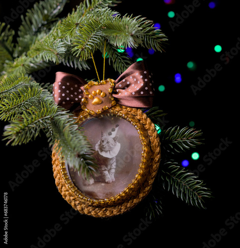 Handmade Christmas tree decoration with vintage cat photo with fairy lights dark background
