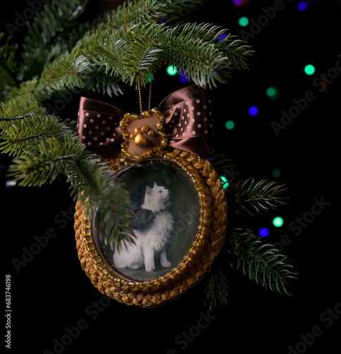 Handmade Christmas tree decoration with vintage cat photo with fairy lights dark background