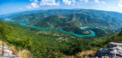 The Kozji Kamen viewpoint offers a beautiful view of Lake Zavojsko, the meanders of the Visocica River and mountain peaks. Serbia near Pirot. Panoramic view of Zavoj lake from viewpoint. photo