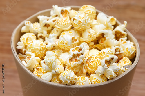 Popcorn. Popcorn scattered throughout the space. A cardboard box. A cloth bag. Space for text. Popcorn Day. January 19. 2024. Popcorn border isolated on white