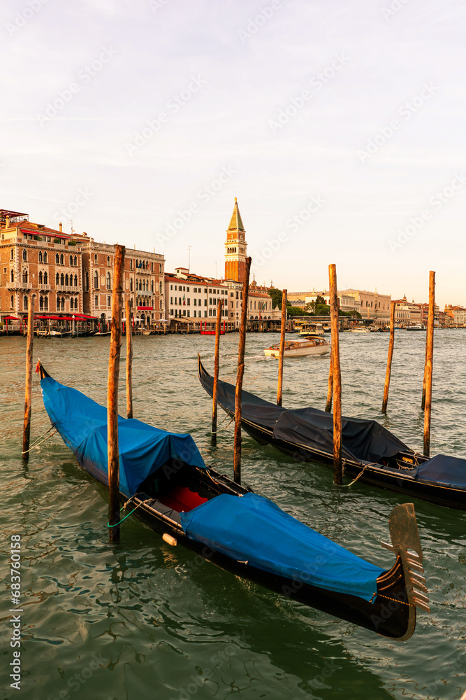 san marco tower view in canals old city of Venice Italy landscape with gondolas, italian palaces in sunset