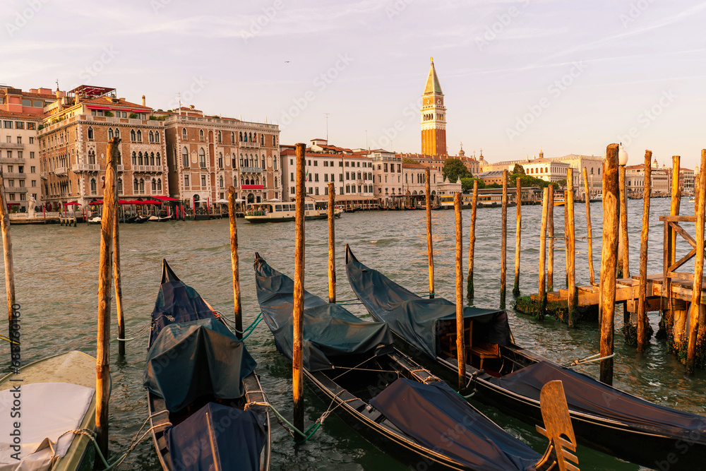 canals in old city of Venice landscape with gondolas, italian palaces and the bell tower of san marco