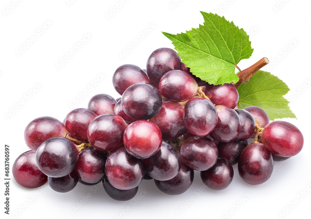 Cluster of red table grape with green leaf isolated on white background.