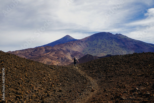 Hiker running on a mountain road in Teide National Park, Tenerife, Canaries, Spain