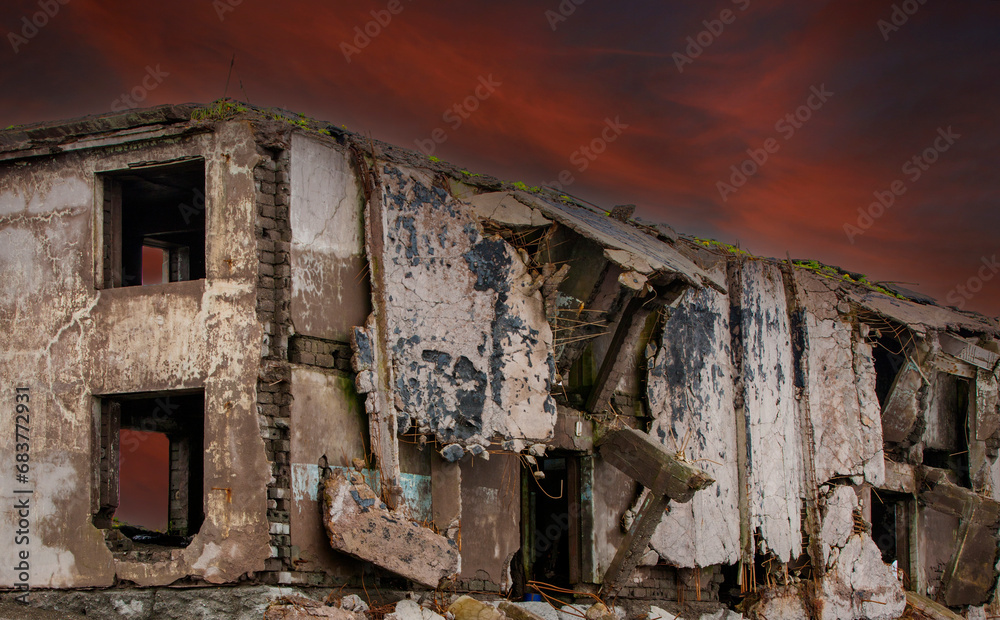 Ruins of a building against a red dark sky background