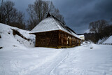 Wooden house in the Ukrainian Carpathians in winter. Wooden hut under the snow.