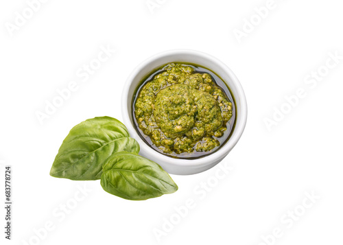 pesto sauce with basil in a gravy boat on a white background