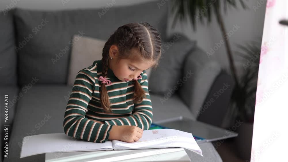 Portrait of happy little girl drawing at home. Girl with beautiful hairstyle using pencils. Five year old kid Portrait of happy little girl drawing at home. Girl with beautiful hairstyle using pencils. Five year old kid