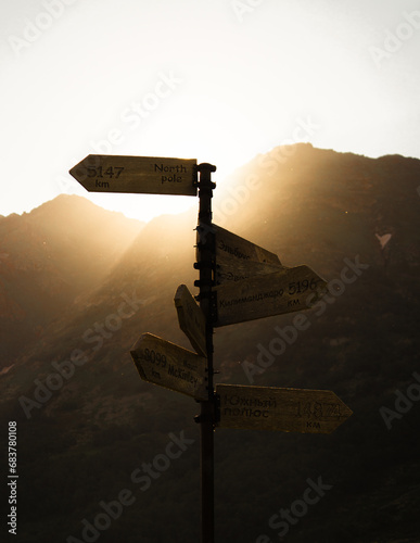 signpost in the mountains sunset mountains 