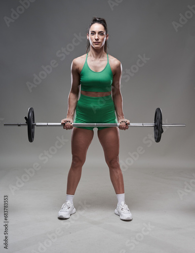 Fitness model lady doing barbell exercises