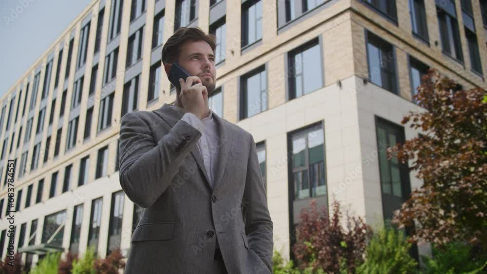 Confident Businessman Speaking on Phone Call Outside Confident Businessman Speaking on Phone Call Outside