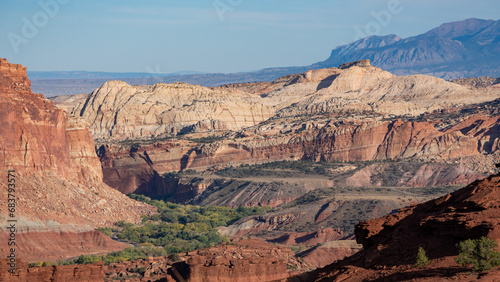 Sandstone rock formation in the American Southwest. Establishing image of the high desert showing massive rock formations with sparse juniper and sagebrush vegetation