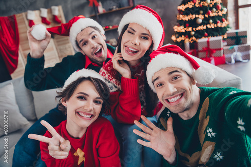 Photo of group cheerful youth fellows take selfie record video christmas greetings tree lights flat indoors