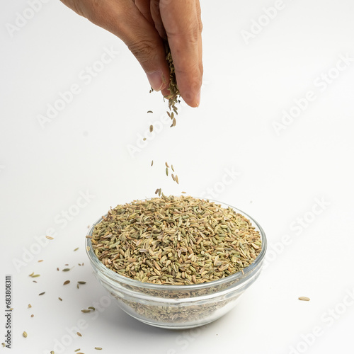 Dry organic Aniseeds in a glass dish on a white background photo