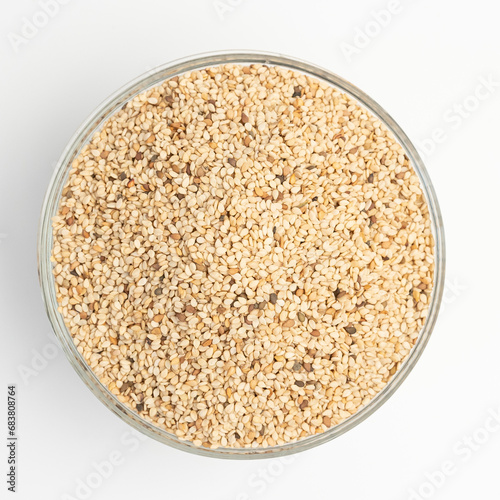Sesame seeds on  on glass plate isolated on a white background  © abdo
