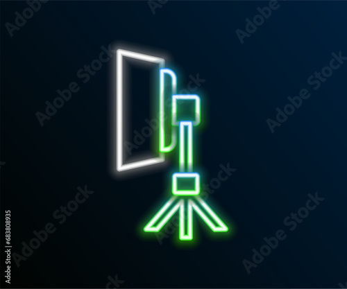 Glowing neon line Studio light bulb in softbox icon isolated on black background. Shadow reflection design. Colorful outline concept. Vector