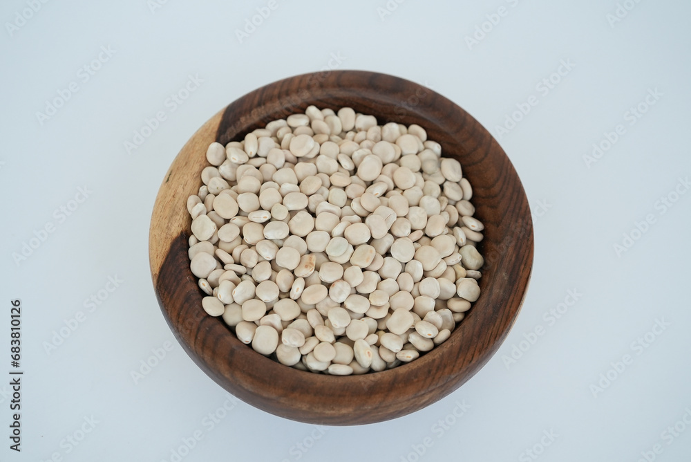 lima beans on a wooden plate isolated on a white background lima beans on a wooden plate isolated on a white background