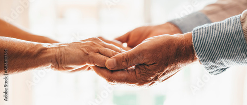 Close up elderly affectionate woman covering wrinkled hands of mature husband, showing love and support at home. Caring middle aged family couple enjoying sincere trustful honest conversation.. photo