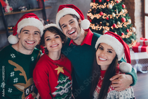 Photo of peaceful positive people toothy smile cuddle cozy christmas time miracle decorated flat inside