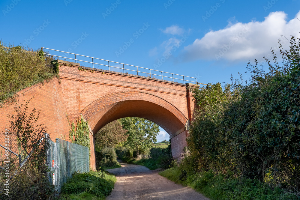 Railway bridge in the countryside against a bright blue sky