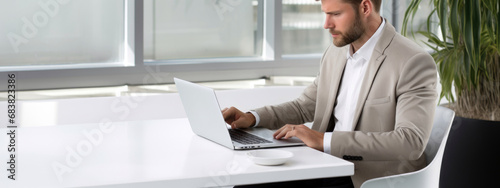 Professional businessman using laptop at office table, copy space