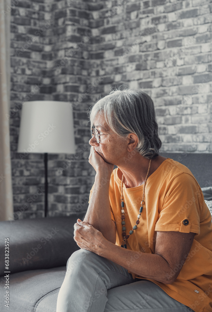 Face of senior caucasian hoary woman looking away deep in sad thoughts feels lonely close up portrait, recollect memories and life moments, depressed grandmother alone indoors, yearning for husband  - obrazy, fototapety, plakaty 