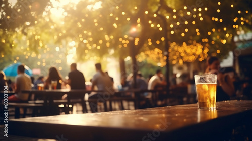 a cold drink and group of people, defocused, at a summer outdoor restaurant and bar, sunny warm lights and soft bokeh, during golden hour