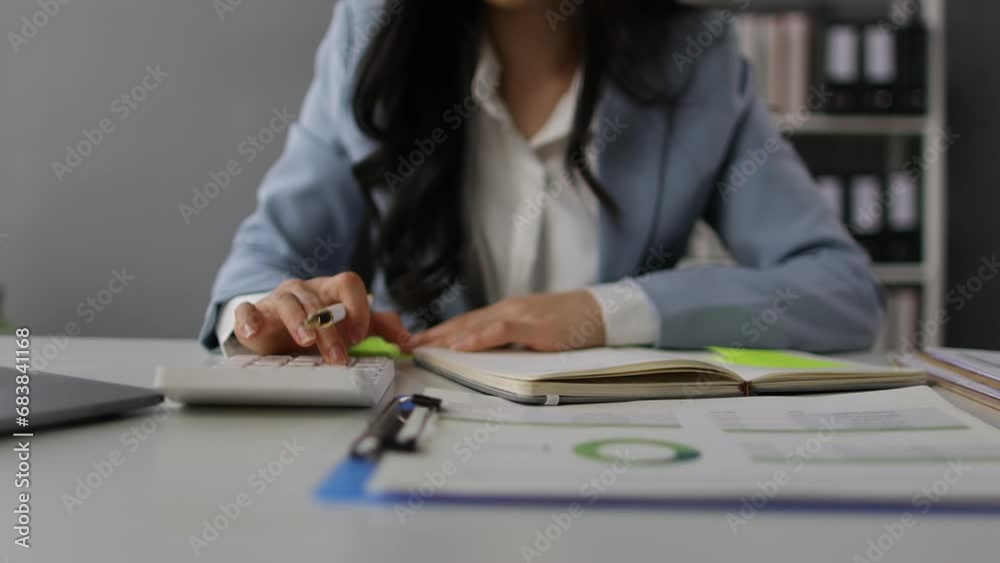 Asian businesswoman working in the office is analyzing data in financial accounting documents. Asian businesswoman working in the office is analyzing data in financial accounting documents.
