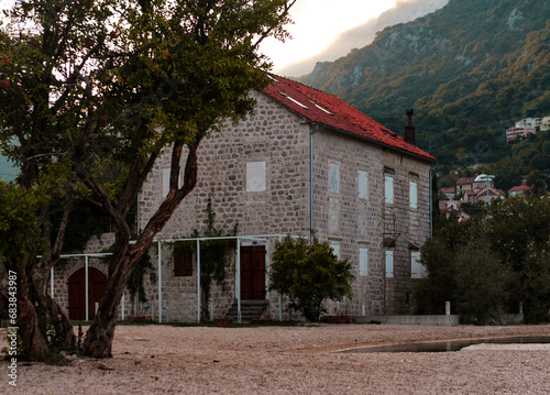 stone house with red tiles on adriatic coast in Montenegro, mountains, autumn landscape photo