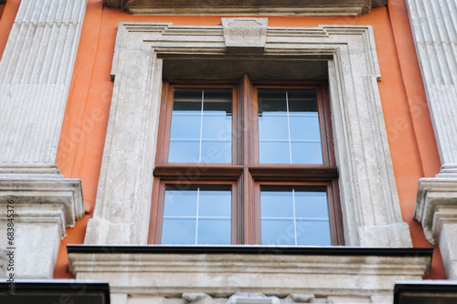 Old decorative architecture in Lviv, Ukraine. Windows on the red facade of the house in the central historical part of the city. photo