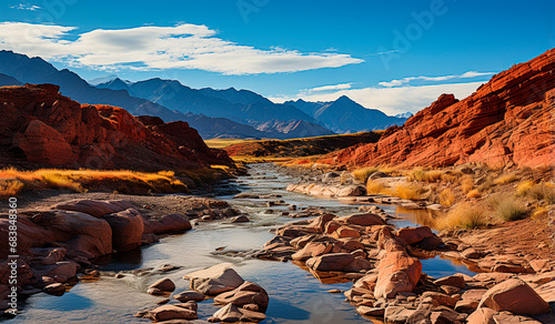 Stunning landscape of red deserts surrounded by white mountains. A unique and picturesque place for lovers of active recreation. A great opportunity for hiking, photography and nature exploration.