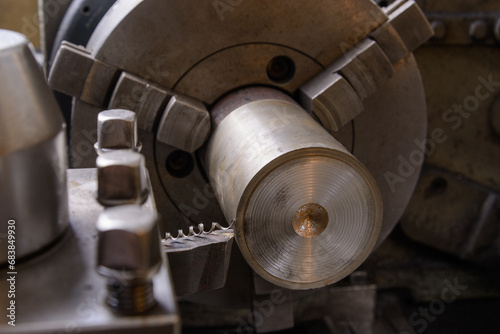 An old lathe at work. Processing the workpiece with a cutter