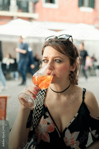 woman drinking Aperol Spritz in cafe