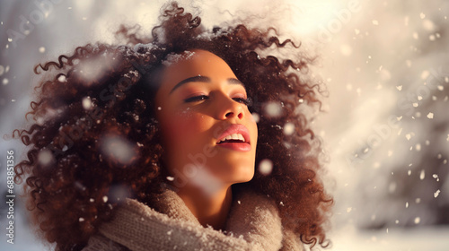 Portrait of a young woman with snowflakes on her face, winter, snowfall. A beautiful girl catches snowflakes with her lips. Girl with dark skin in winter. Enjoy the weather