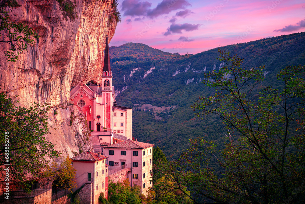 Madonna della Corona, Italy. Aerial image of the unique Sanctuary Madonna della Corona (Sanctuary of the Lady of the Crown) was built in the rock, located in the Alps in Italy at autumn sunrise.