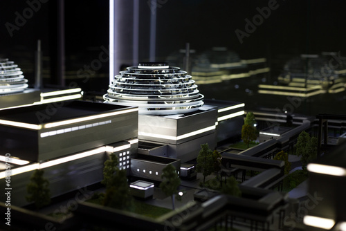 Fototapeta Naklejka Na Ścianę i Meble -  Scale model of a modern building with lighting and a dome on the roof. Streets made of plastic to demonstrate the construction of the future