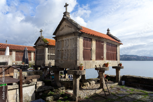 Fishing village of Combarro with the typical horreos (fish drying sheds). Galicia, Spain. photo