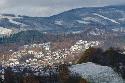 Fototapeta Naklejka Na Ścianę i Meble -  Residential area in city Zubri near to Roznov pod Radhostem. Very small Czech city on the foothills covered by first snow in late autumn. Winter is coming. Czech republic countryside.