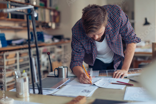Male artist doing home interior design in the office photo