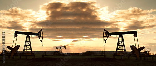 Oil rig at sunset the sun. Silhouette of Pump Jack are running.