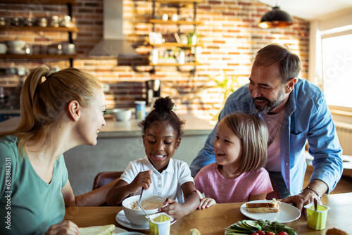 Family Enjoying Breakfast Together, Smiling and Conversation