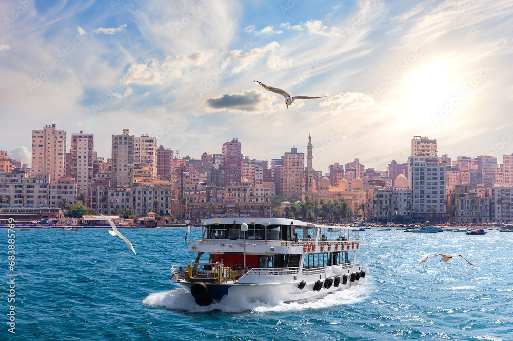 Naklejka premium Cruise ship by the shore of the sea, area of he Abu al-Abbas al-Mursi Mosque in Alexandria, Egypt