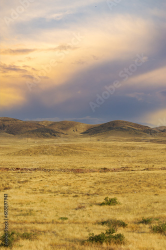 Steppe, prairie, plain, pampa. Nature puts on a mesmerizing show as the sun slides behind the prairie's horizon, leaving behind a sky painted with vivid cascades of color! Sunset Splendor, Panorama