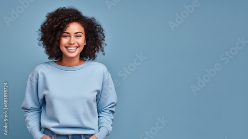 Afro american woman wearing blue sweatshirt isolated on pastel photo