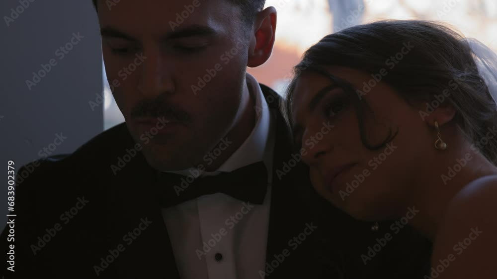 Bride rests on grooms shoulder as they eat desert at their wedding Bride rests on grooms shoulder as they eat desert at their wedding