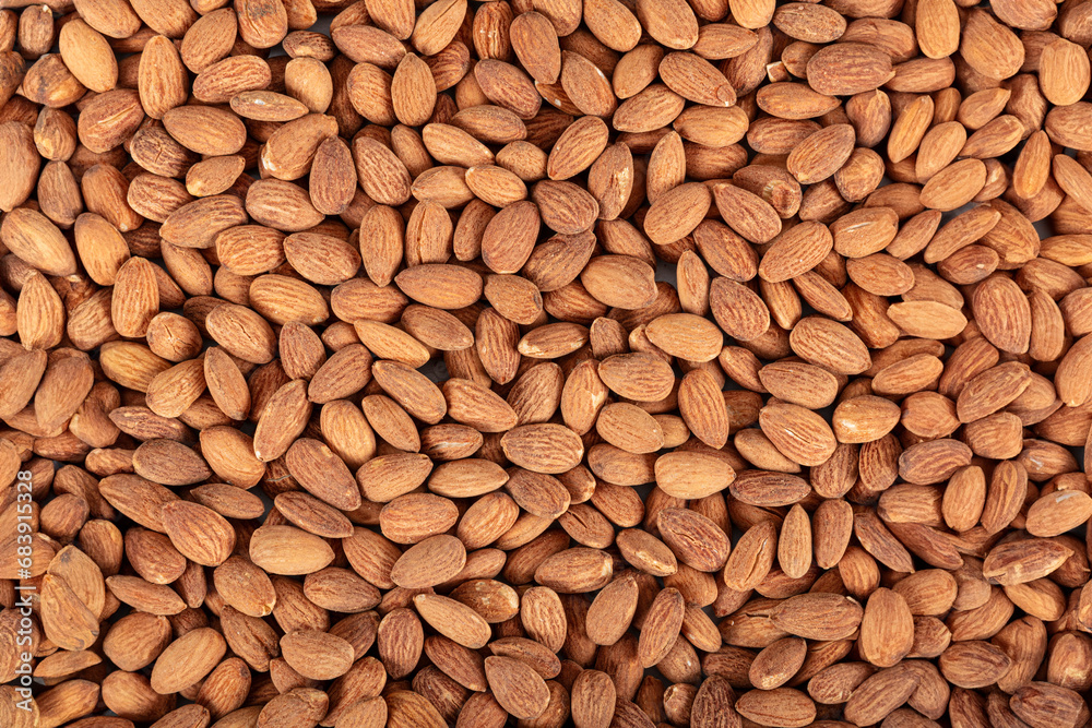 A portion of hickory smoked almonds isolated on a white background. Background of large raw shelled almonds, arranged randomly shot large, shelled nuts for vegans. A portion of hickory smoked almonds isolated on a white background. Background of large raw shelled almonds, arranged randomly shot large, shelled nuts for vegans.