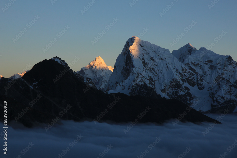 Sun lit mountains Ama Dablam and Cholatse at sunset, Nepal.